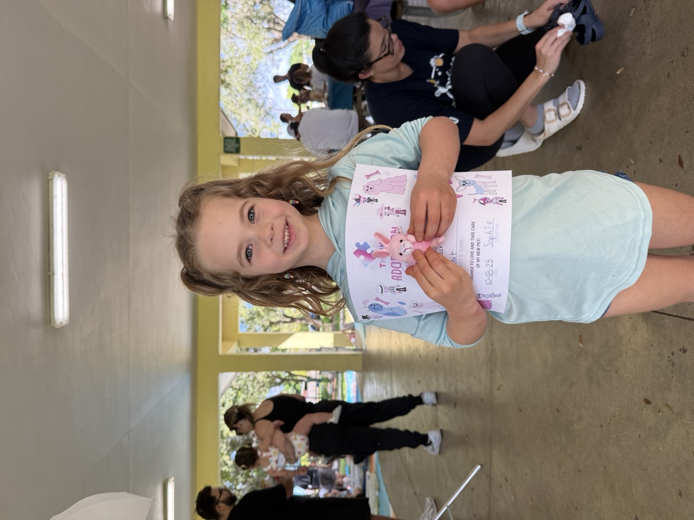 Girl beaming with heart artwork at event